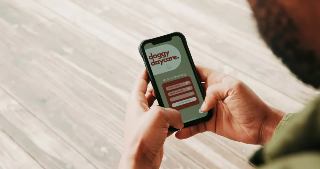 Pet pro uses doggy daycare booking software on a phone app